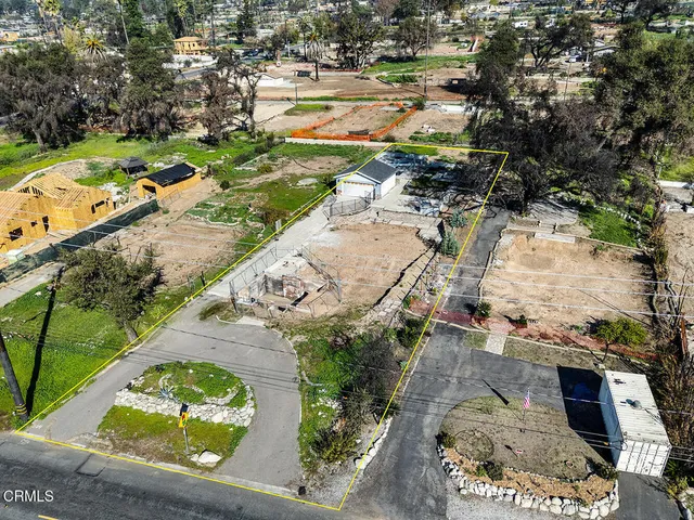 an aerial view of a residential houses with outdoor space