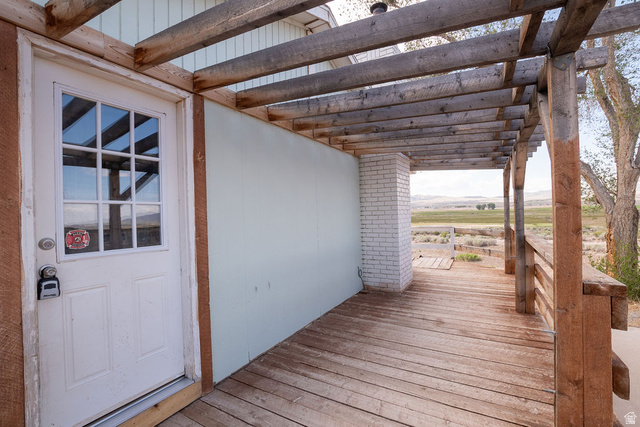 570 West Main Street Beaver, UT 84713 - Photo 32 of 43 Expansive outdoor deck featuring weathered wood planks and a coordinating wood pergola structure