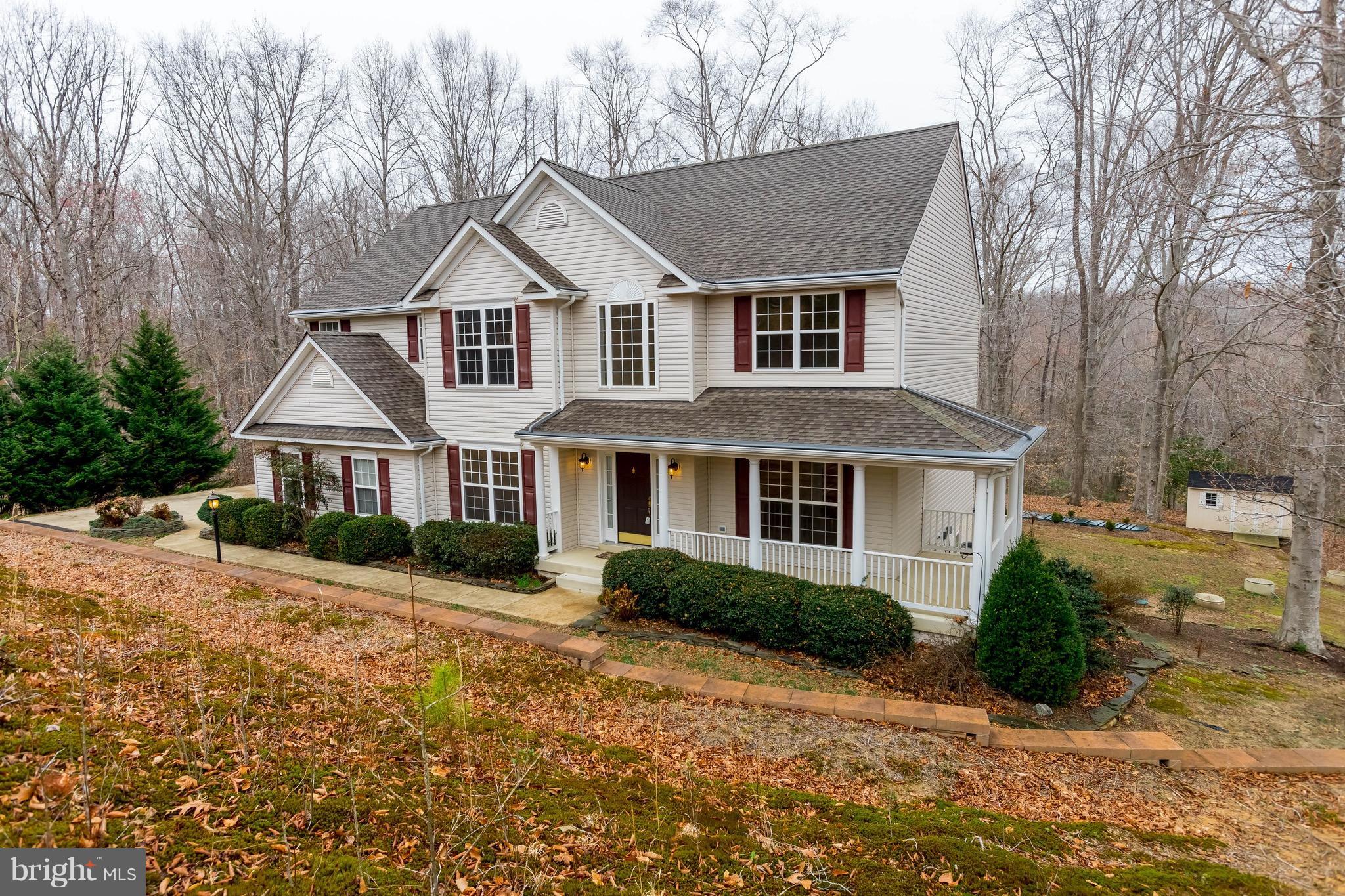 6732 North Stuart Road King George, VA 22485 - Photo 2 of 30 a front view of a house with a yard and potted plants