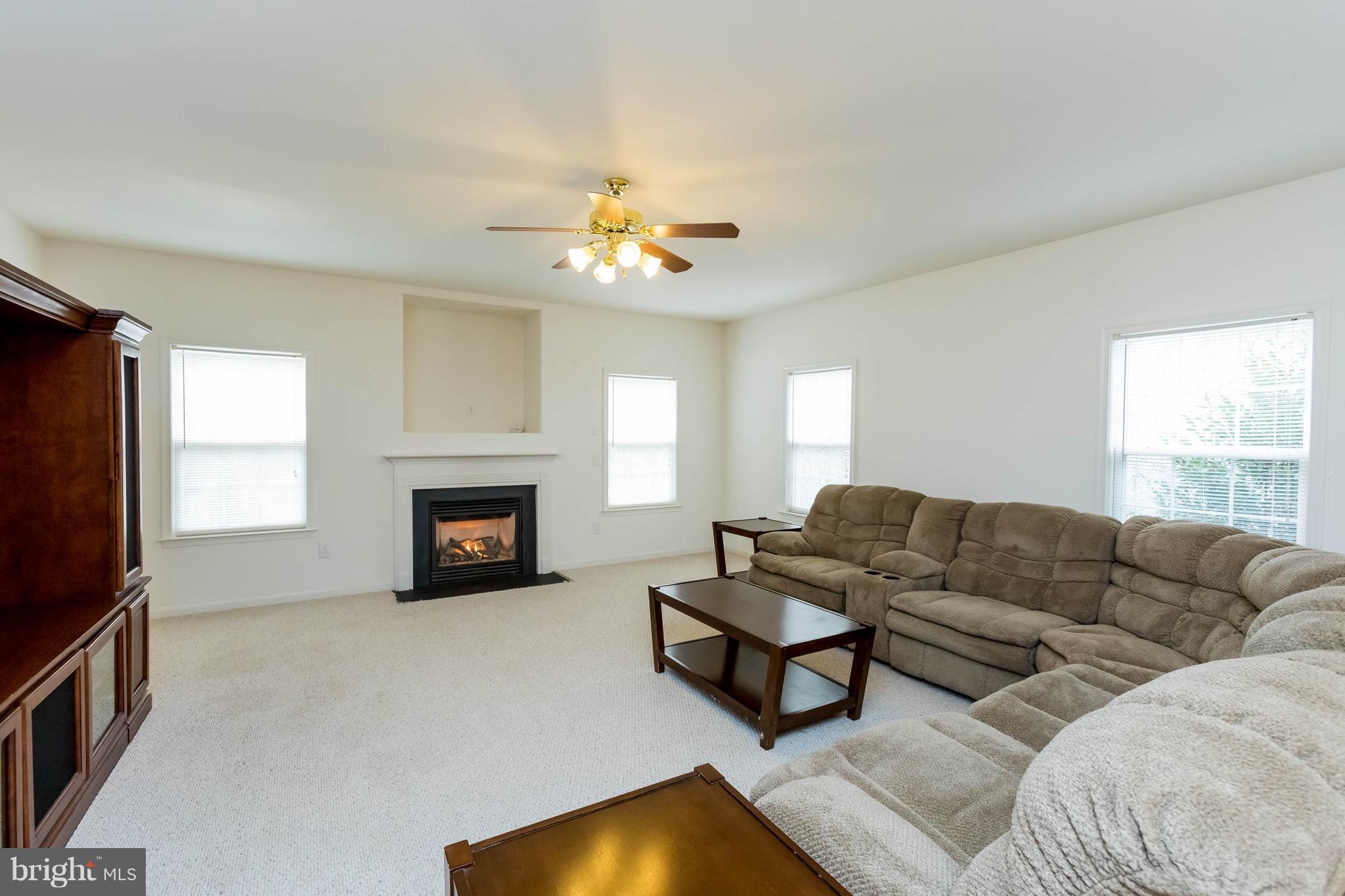 6732 North Stuart Road King George, VA 22485 - Photo 14 of 30 a living room with furniture a fireplace and a flat screen tv