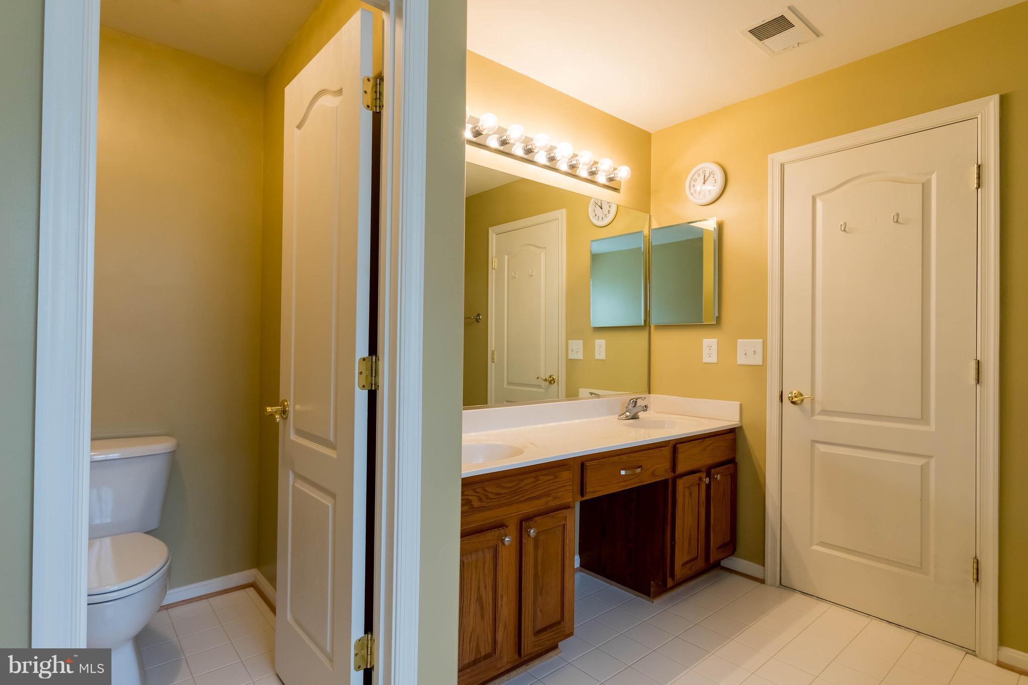 6732 North Stuart Road King George, VA 22485 - Photo 19 of 30 a spacious bathroom with a double vanity sink and a mirror