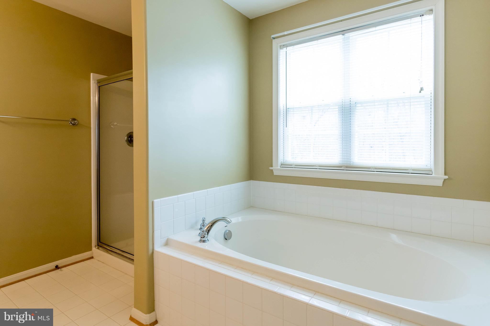 6732 North Stuart Road King George, VA 22485 - Photo 20 of 30 a white bath tub sitting next to a window