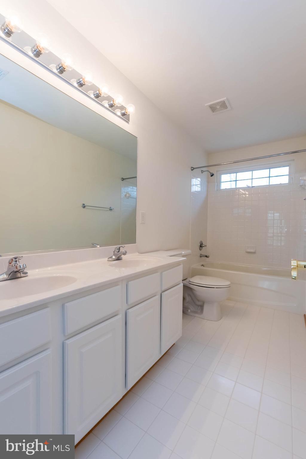 6732 North Stuart Road King George, VA 22485 - Photo 23 of 30 a bathroom with a granite countertop sink mirror and toilet