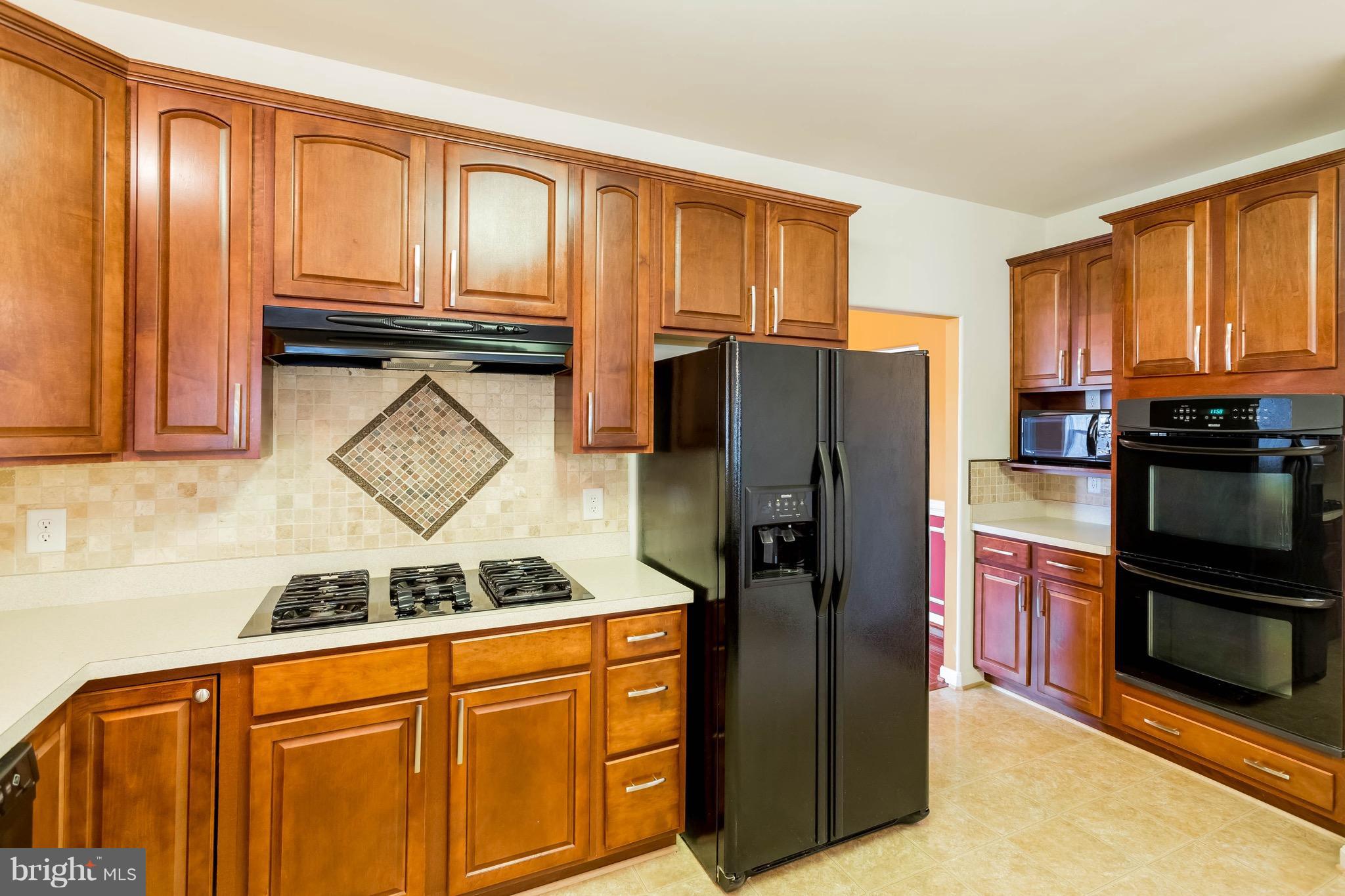 6732 North Stuart Road King George, VA 22485 - Photo 8 of 30 a kitchen with stainless steel appliances granite countertop a refrigerator stove and cabinets