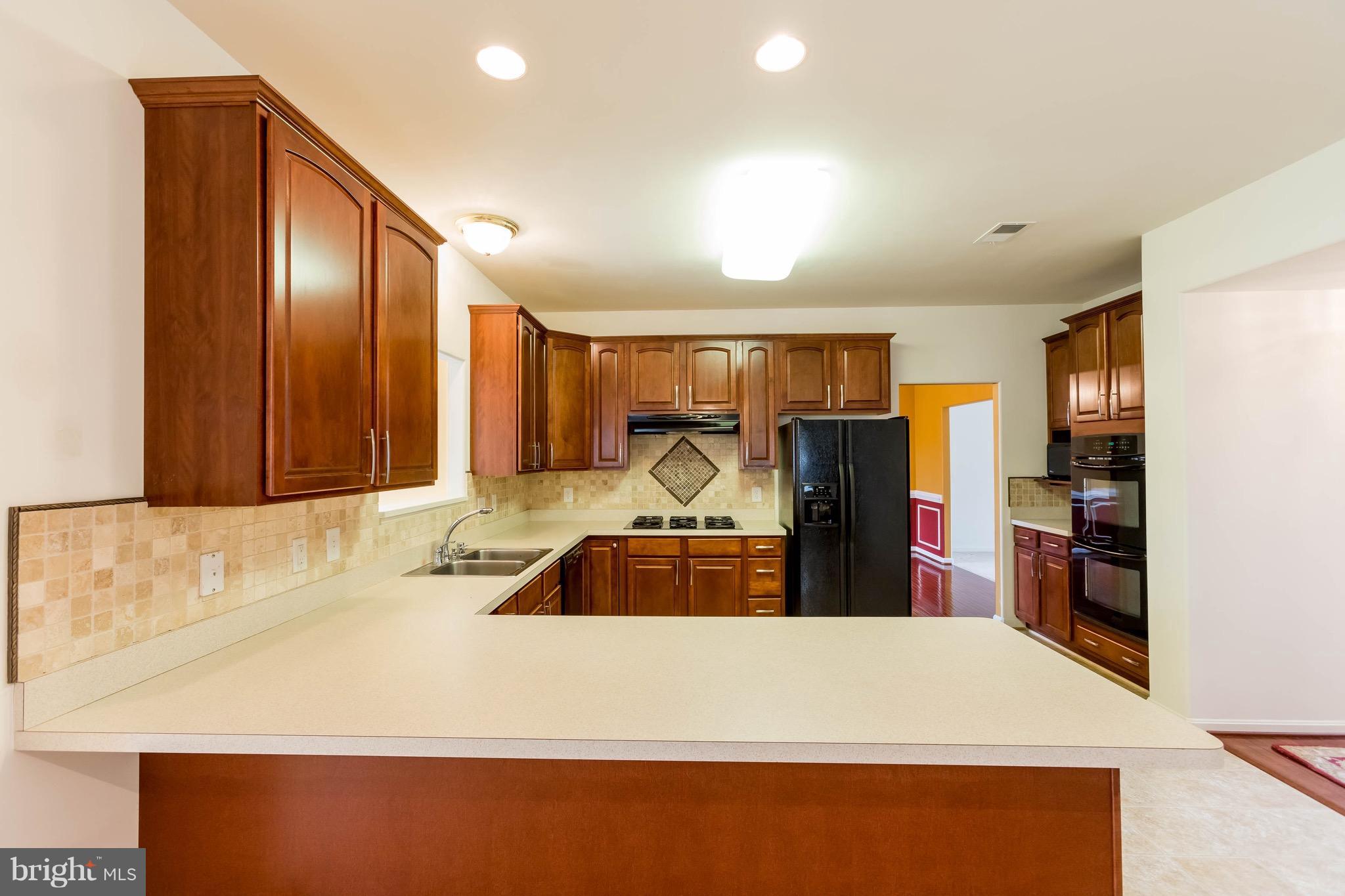 6732 North Stuart Road King George, VA 22485 - Photo 9 of 30 a kitchen with a refrigerator and a sink