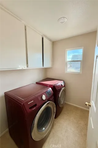 a utility room with window and washing machine