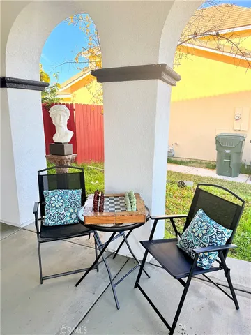a living room with furniture and a floor to ceiling window
