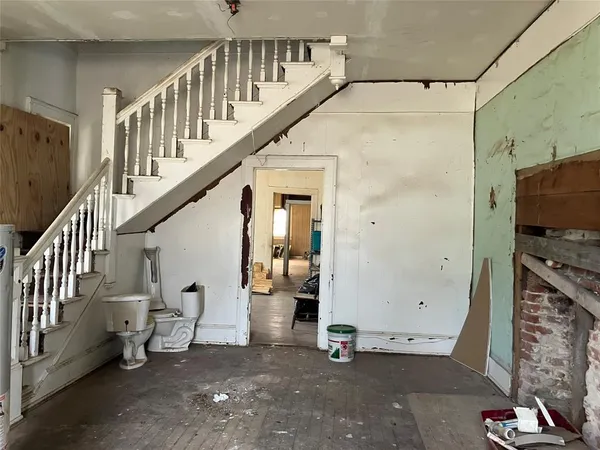 a view of hallway with stairs and furniture