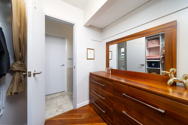 a room with a bed and a dresser