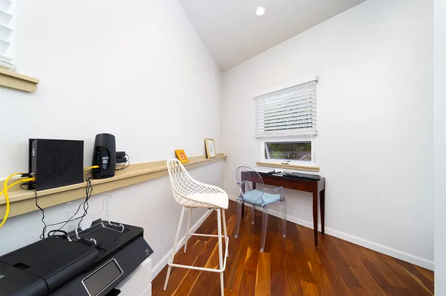 a work room with furniture and wooden floor