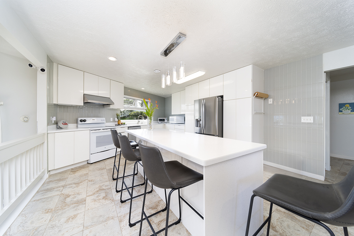420 Huali Place Hilo, HI 96720 - Photo 6 of 30 a kitchen with a table chairs refrigerator and microwave
