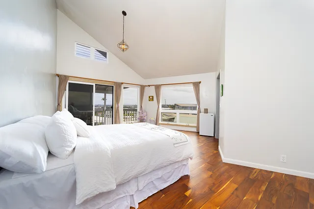 a bedroom with a large bed window and walk in closet