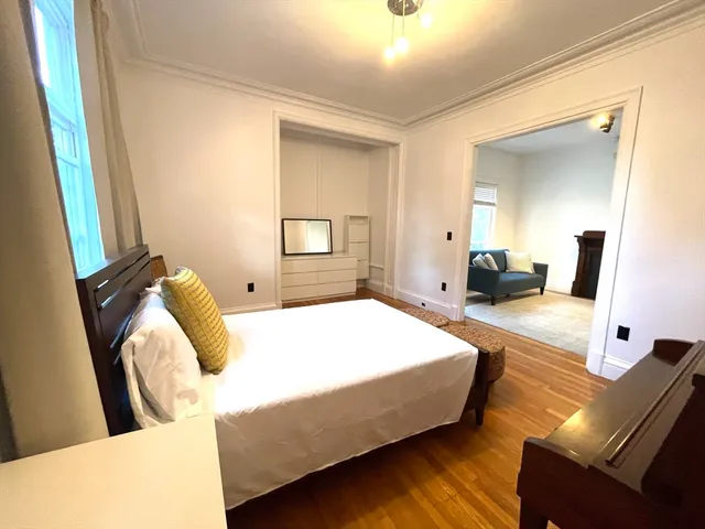 a bedroom with bed and window