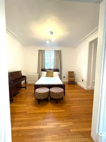 a spacious bedroom with a bed and window