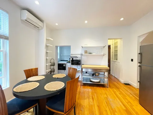 a dining room with a table and chairs