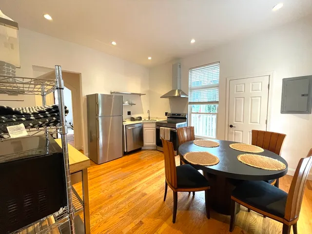 a large kitchen with a table and chairs