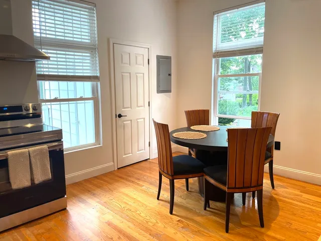 a view of a dining room with furniture window and wooden floor