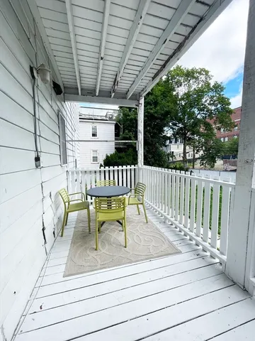 a view of a patio with a table and chairs