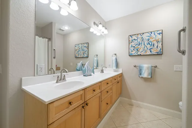 a bathroom with a sink a mirror and a vanity