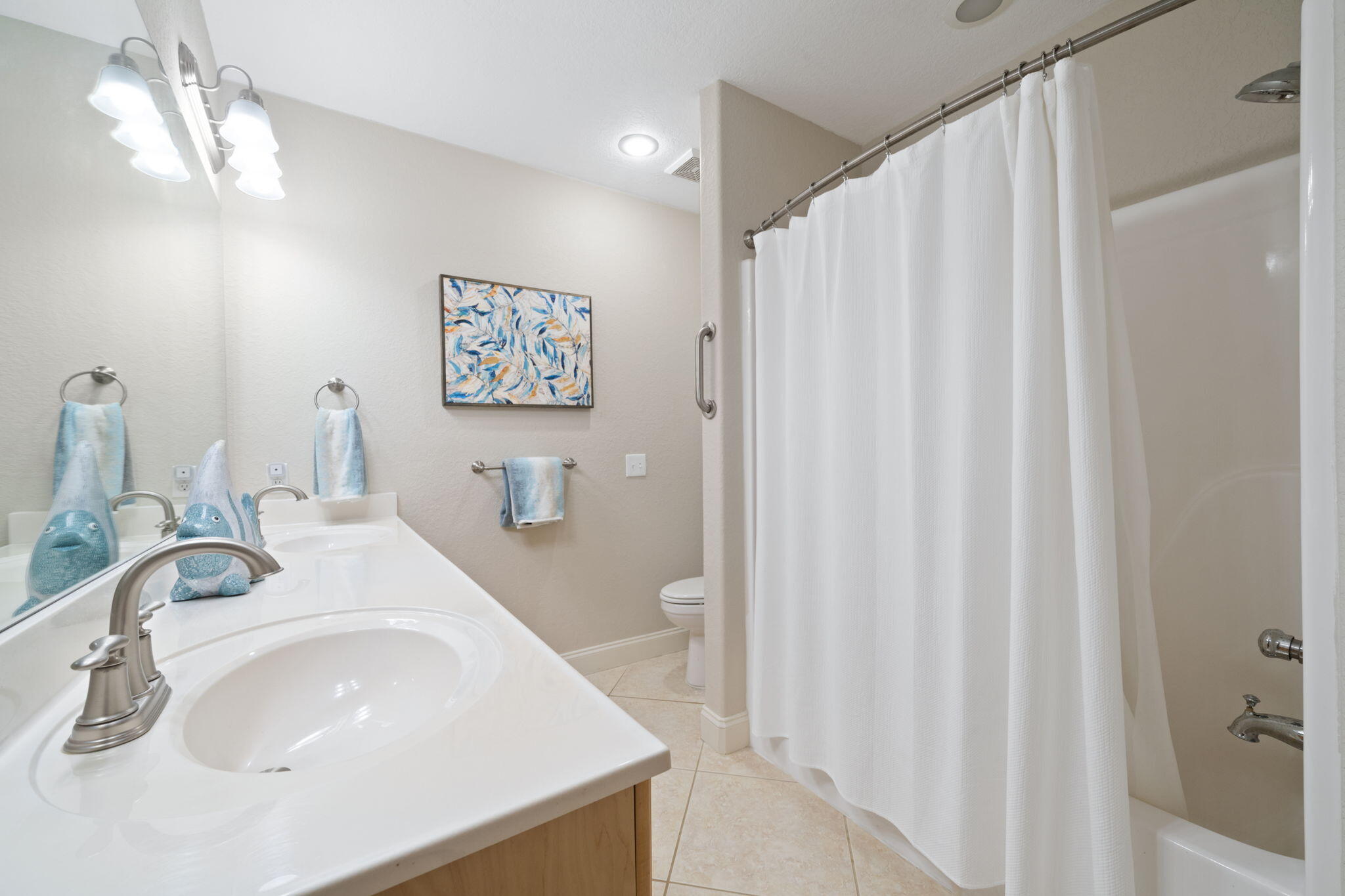 602 Harbor Boulevard, Unit 103 Destin, FL 32541 - Photo 15 of 47 a bathroom with a sink and a mirror