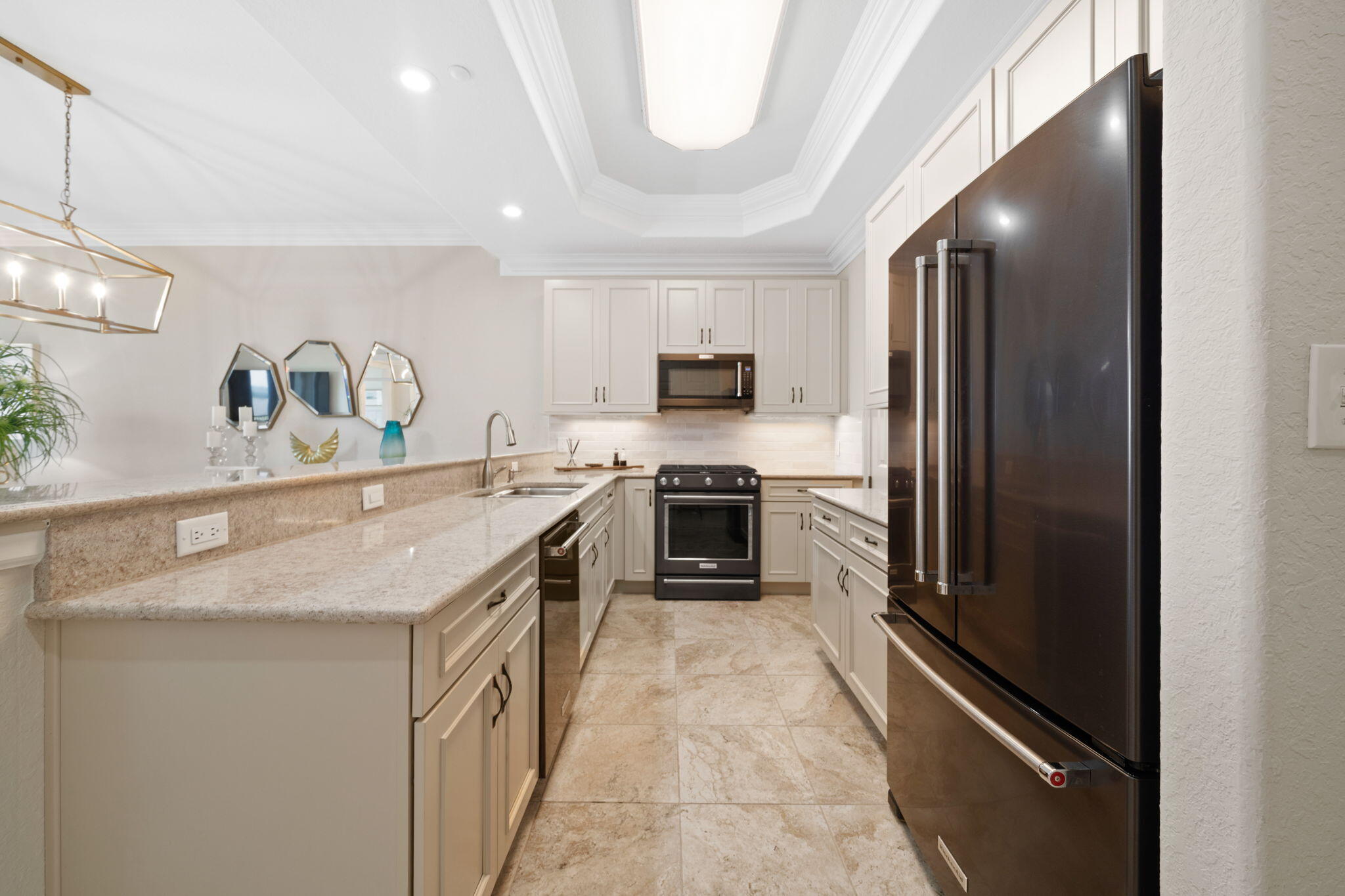 602 Harbor Boulevard, Unit 103 Destin, FL 32541 - Photo 16 of 47 a kitchen with a sink stainless steel appliances a counter top space and cabinets