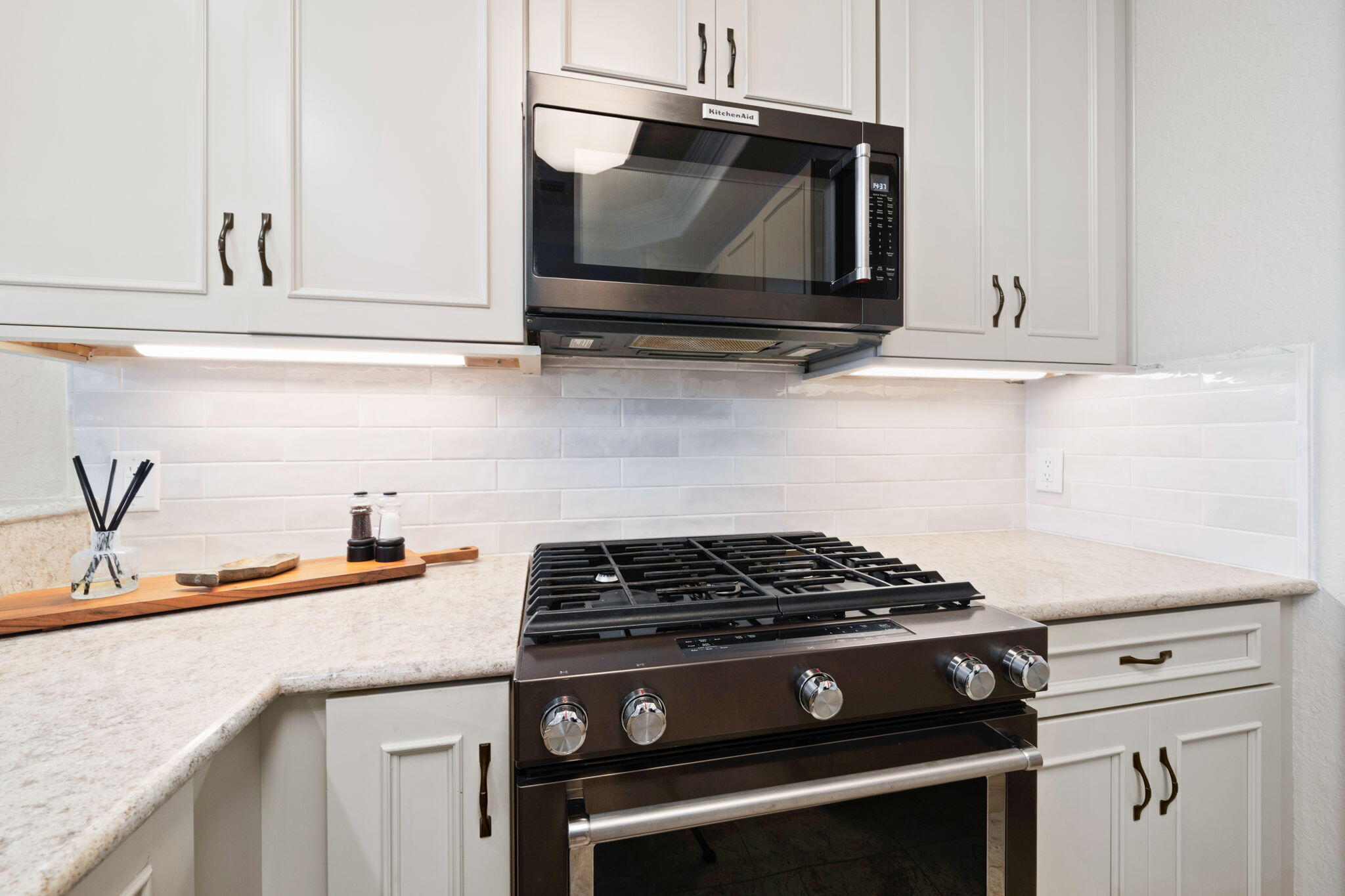 602 Harbor Boulevard, Unit 103 Destin, FL 32541 - Photo 17 of 47 a kitchen with granite countertop cabinets stainless steel appliances and wooden floor