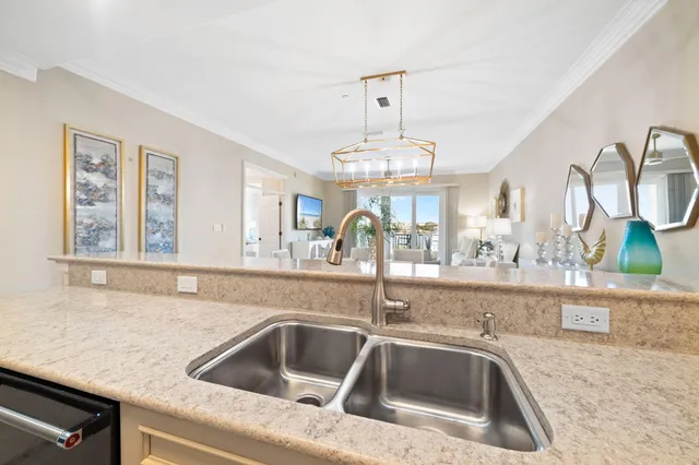 a kitchen with a sink and chandelier