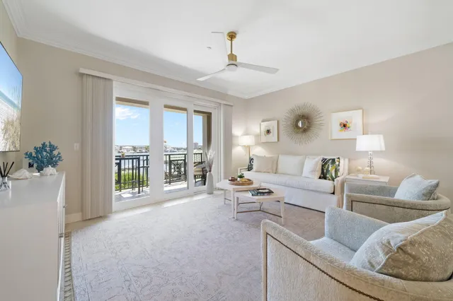 a living room with furniture and large windows