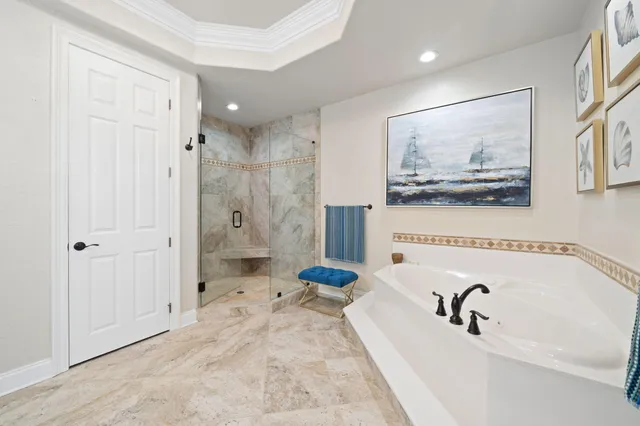 a bathroom with a tub sink and mirror