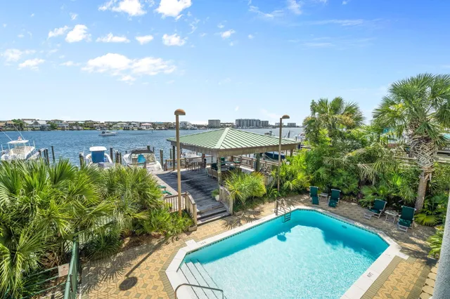 a view of a swimming pool with a patio and a yard