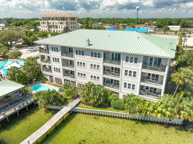 a view of a large building with a swimming pool and lawn chairs