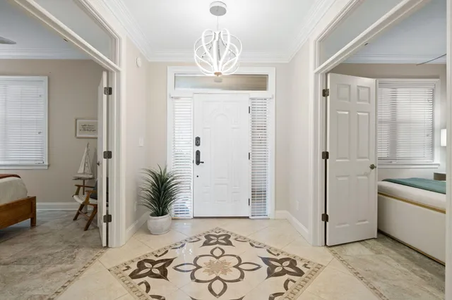 a room with a bed and a chandelier