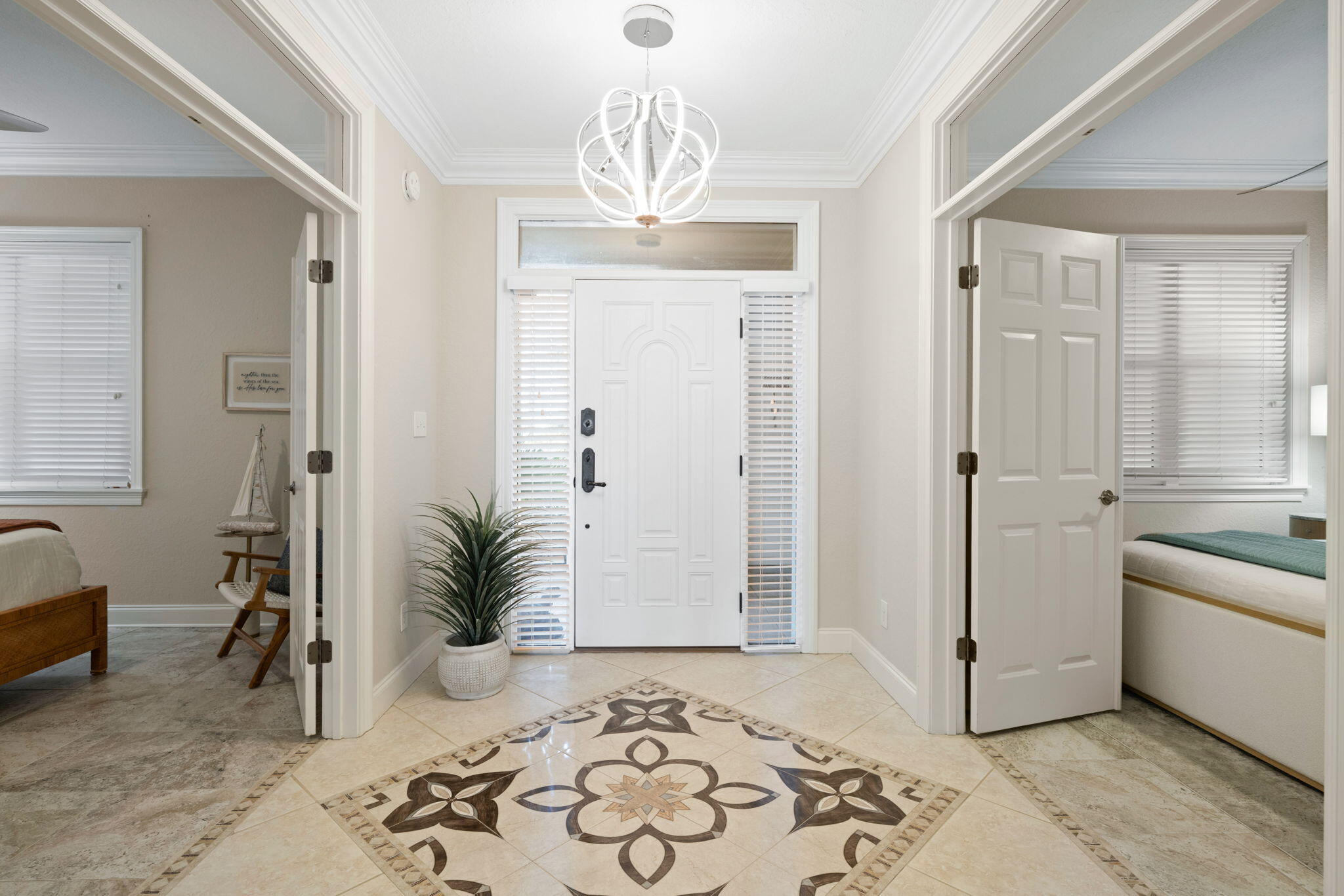 602 Harbor Boulevard, Unit 103 Destin, FL 32541 - Photo 7 of 47 a room with a bed and a chandelier