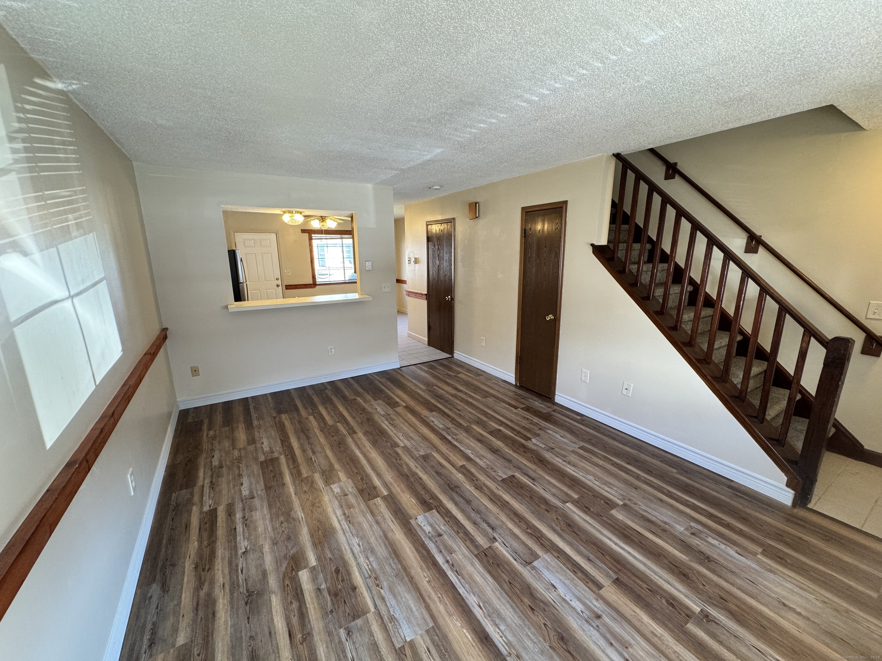 a view of a room with wooden floor and windows