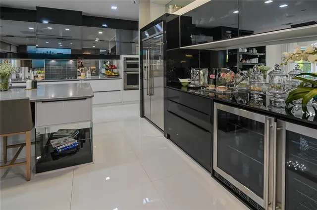 a kitchen area with stainless steel appliances a stove and cabinets