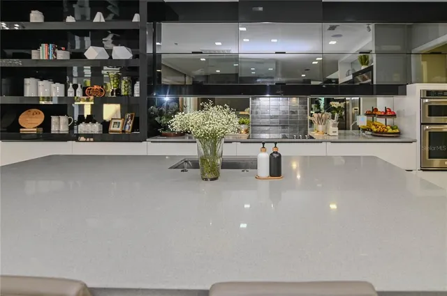 a kitchen with granite countertop a stove and a microwave