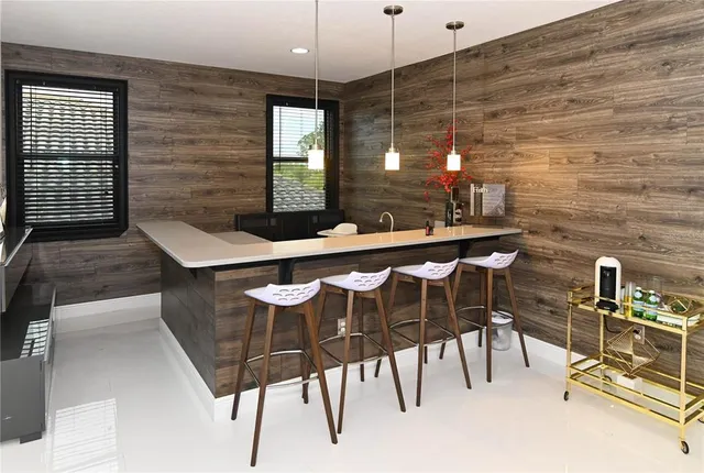 a living room with furniture and large flat screen tv