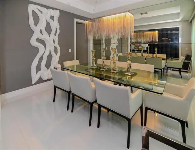 a dining room with furniture and a large window