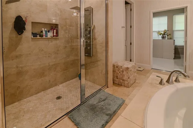 a view of walk in closet with clothes and shoes