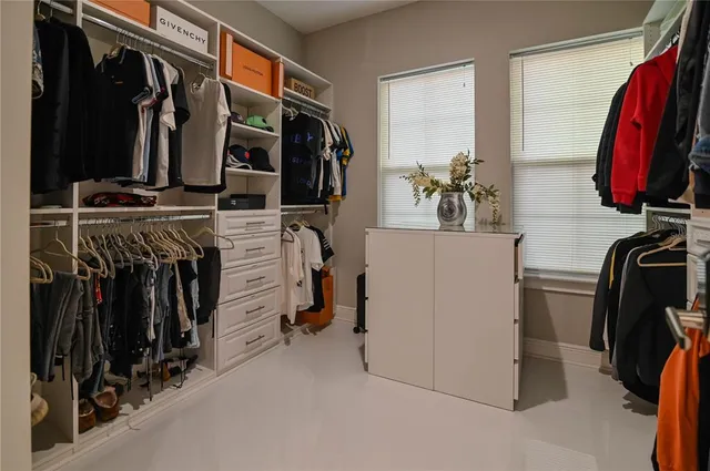 a living room with a couch and a floor to ceiling window