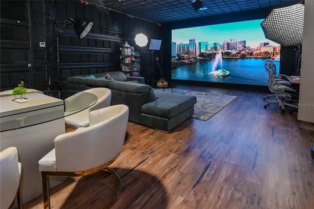 a view of a patio with a dining table and chairs with a balcony