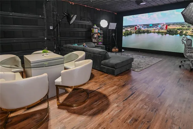 a view of a patio with table and chairs potted plants and palm trees