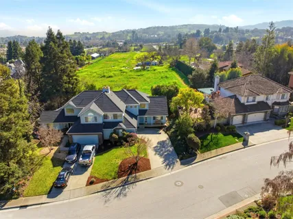 an aerial view of residential houses with outdoor space and street view