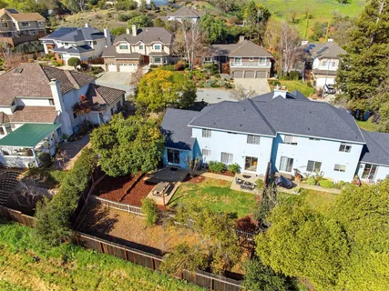 an aerial view of house with yard swimming pool and outdoor seating