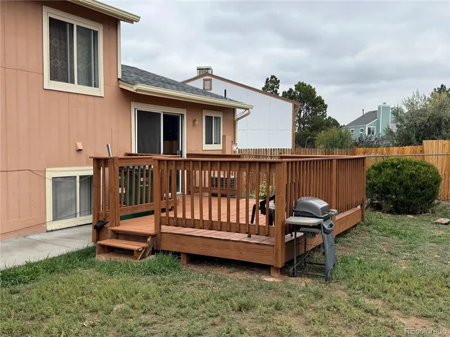 a view of a deck with a bench next to a yard