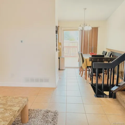 a view of a dining room with furniture and window