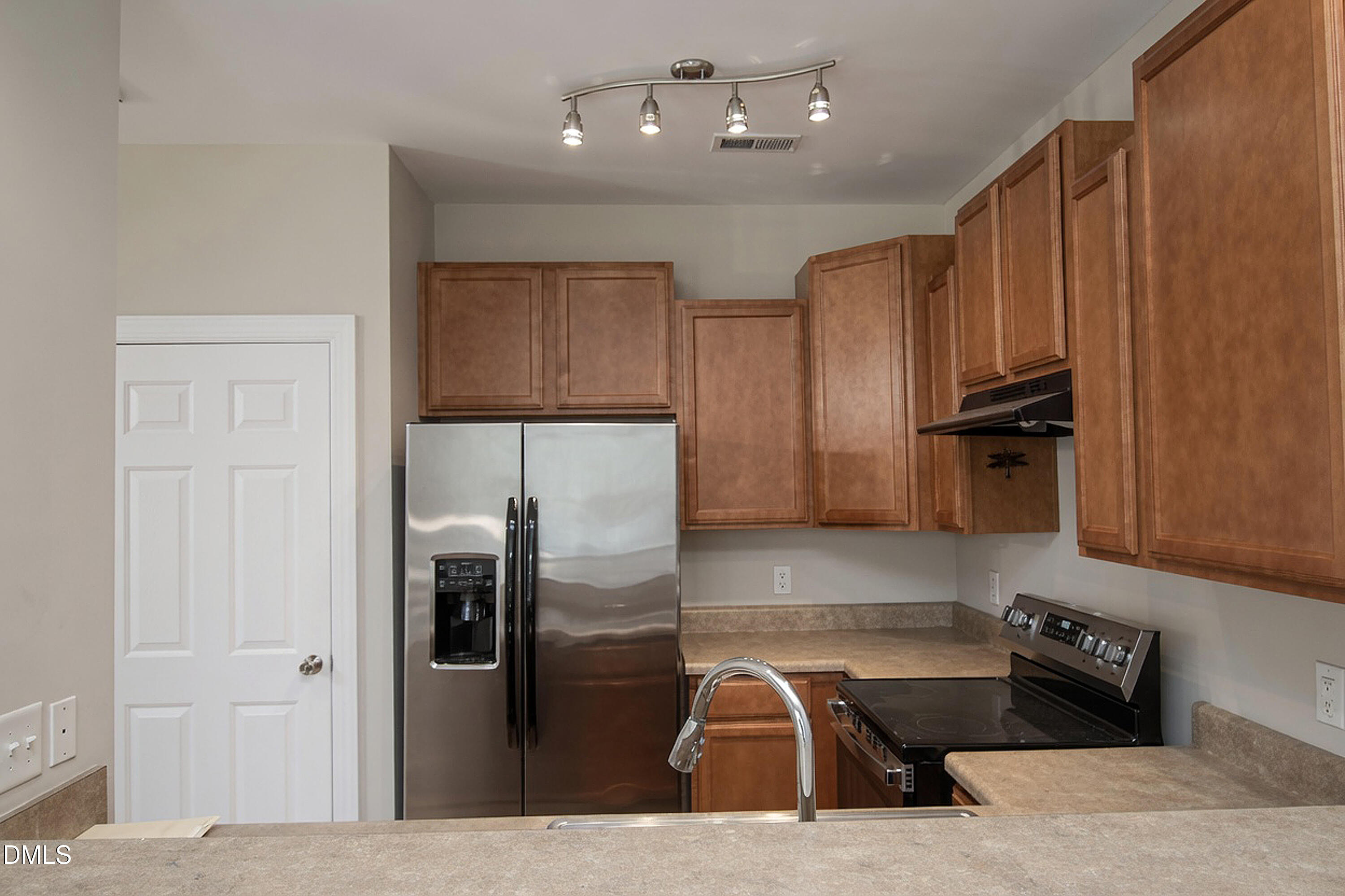 4809 Landover Pine Place Raleigh, NC 27616 - Photo 5 of 14 a kitchen with stainless steel appliances granite countertop a refrigerator a stove and a sink with wooden floor