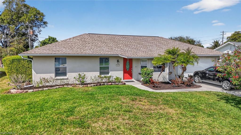 Ranch-style home featuring stucco siding, driveway, shingle's roof,  attached garage, and a front lawn.