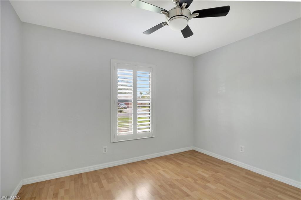 3035 42nd Terrace Southwest Naples, FL 34116 - Photo 22 of 48 Spare room with light wood-style floors and a ceiling fan.