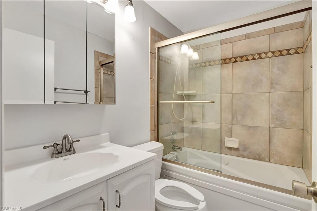 3035 42nd Terrace Southwest Naples, FL 34116 - Photo 26 of 48 Guest Bathroom with vanity and combined bath / shower with glass slider door.